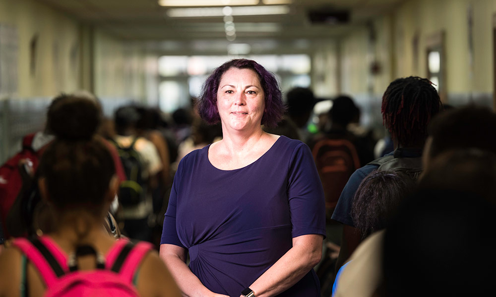 Feature image photo of Joanne Larson in crowded school hallway