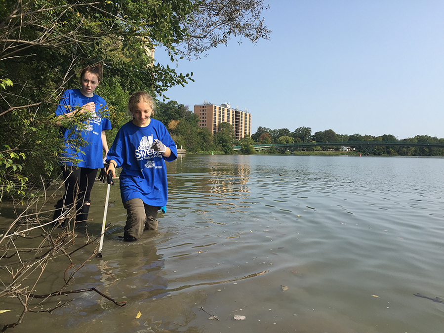 two students wading in the river 