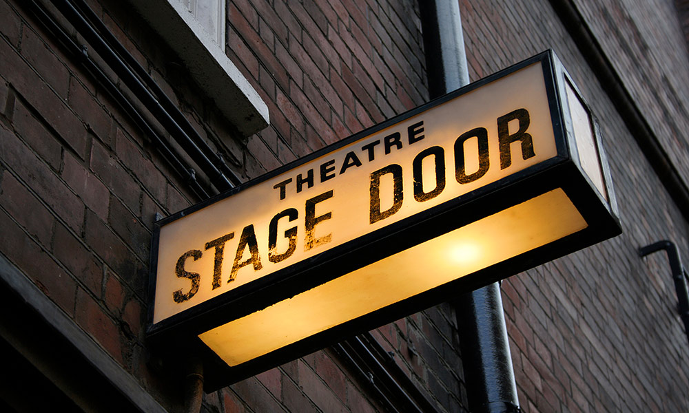 Feature image lighted sign reads STAGE DOOR