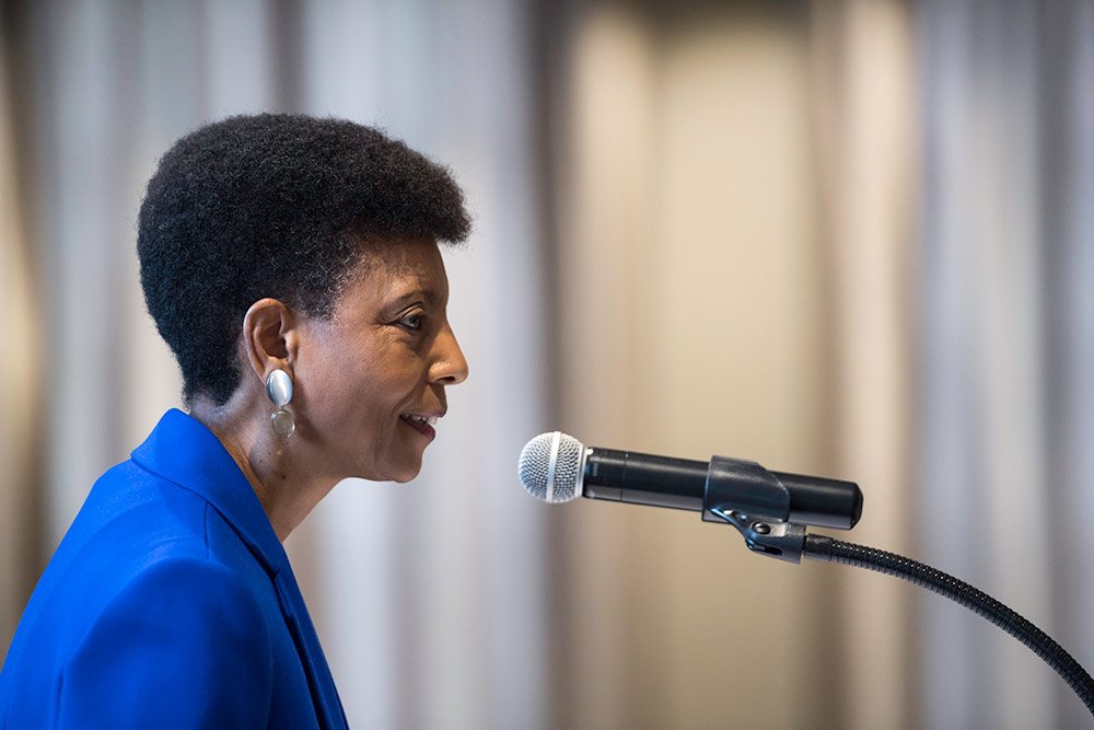 woman speaking behind a microphone