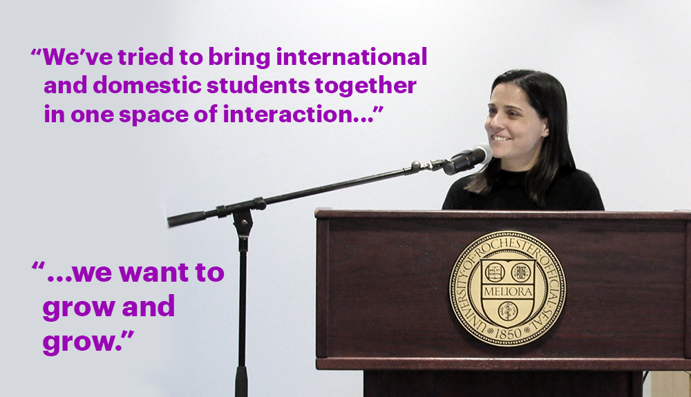 Teresa Valdez behind a podium at the Language Center, with the words