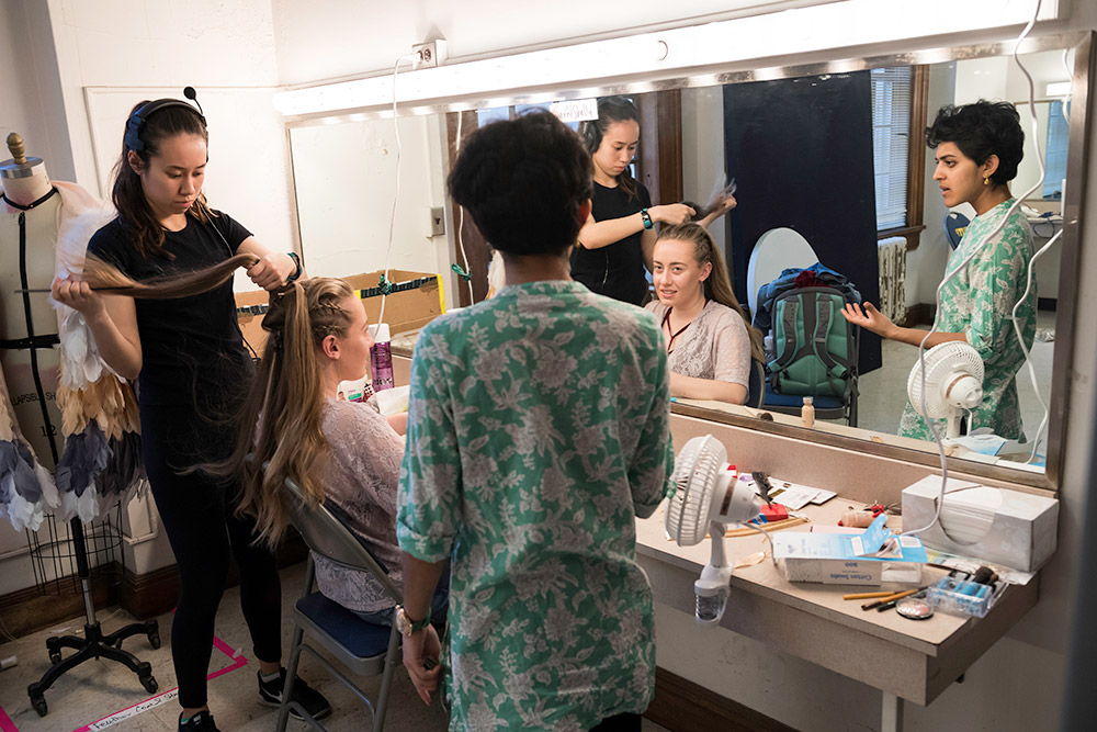 group of student actors in front of a mirror