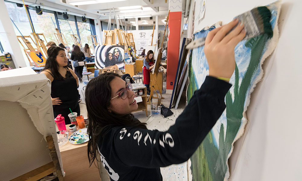 Feature image students painting in a busy art studio