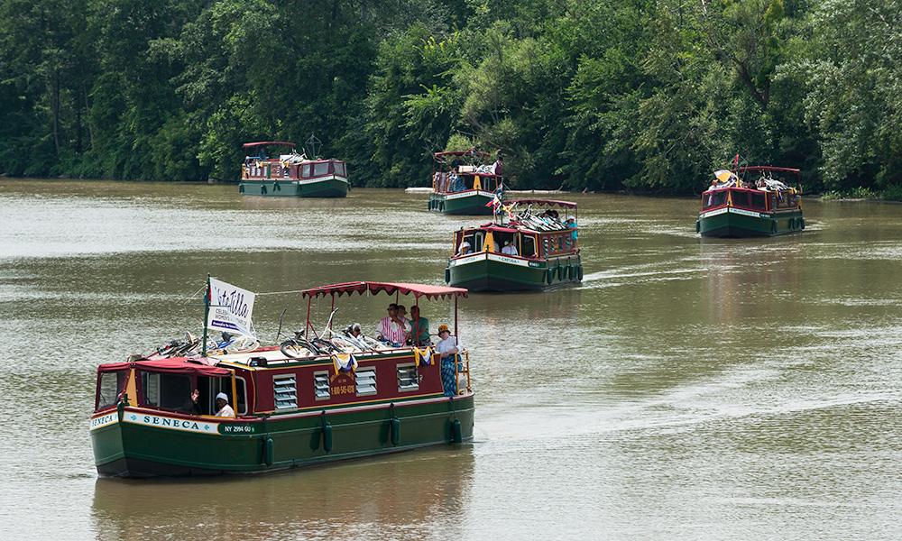 Feature image canal boats on the Erie Canal carrying suffrage reenactors