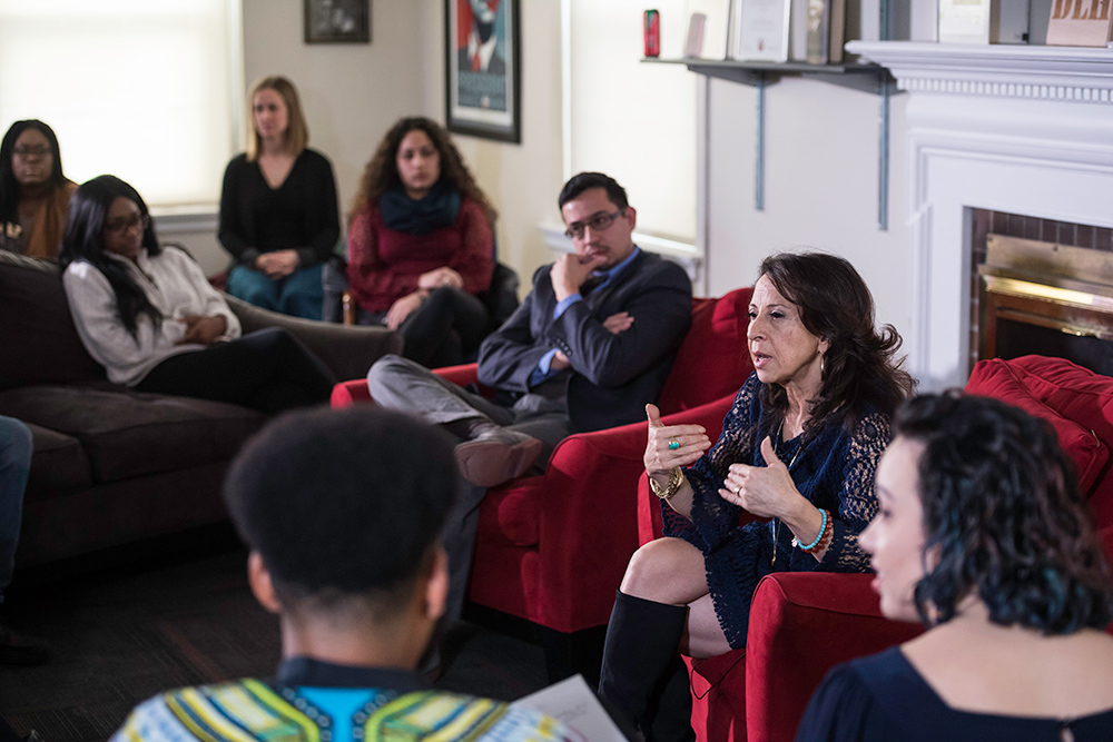 Feature image Maria Hinojosa sitting with a large group of students