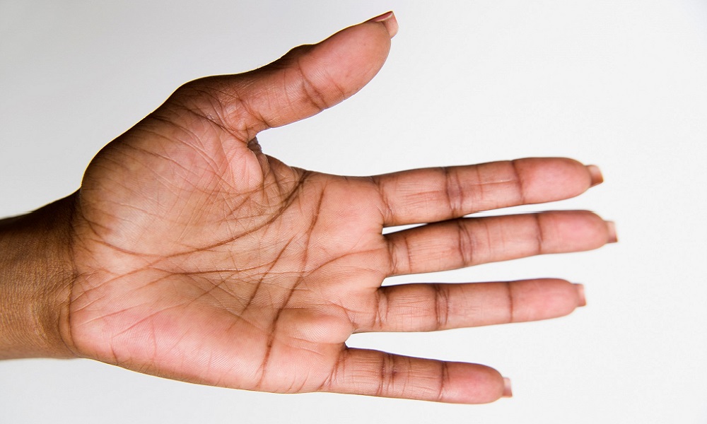 Black woman's hand shown palm facing upward.