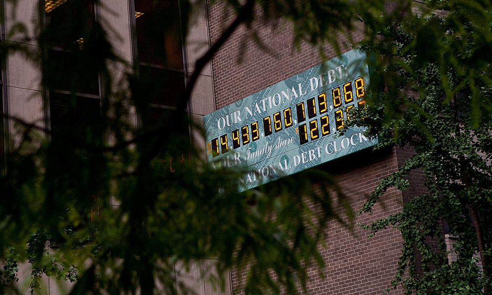 Feature image The lighted National Debt Clock sign reads $14 trillion