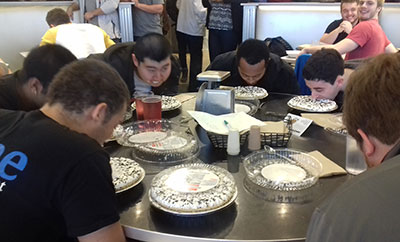 large group of students eating pies