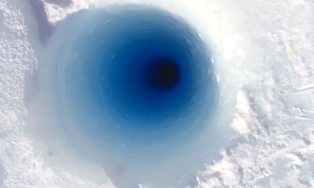 Feature image still from a video shows of core or hole in a glacier