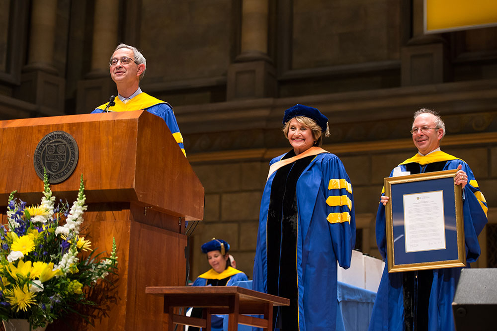 Louise Slaughter on stage at commencement being presented with an award