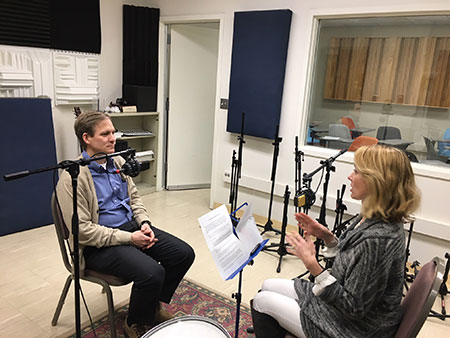 two people sitting in a recording studio