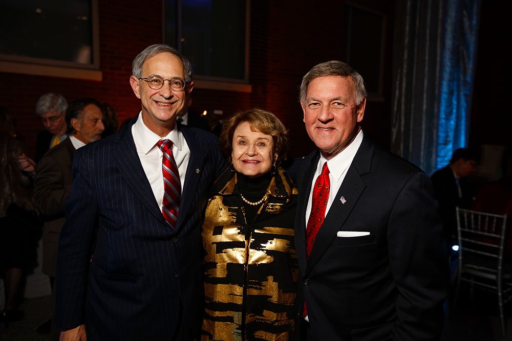 three people pose for a portrait