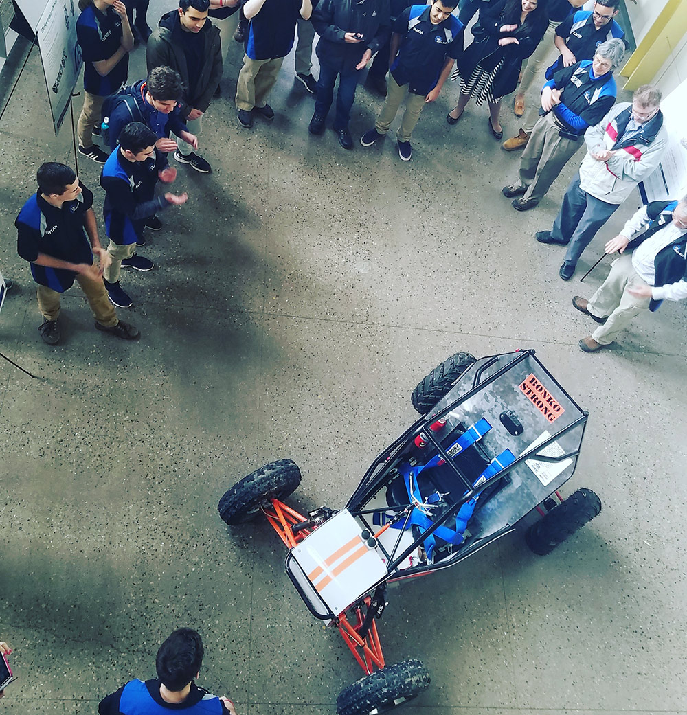Feature image crowd of people gathered around a racing car