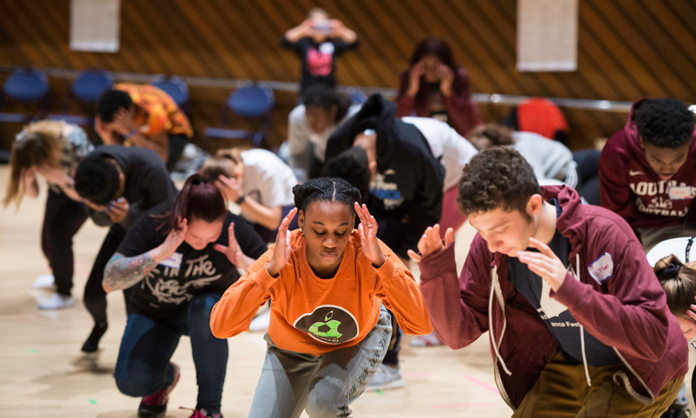 Feature image group of students dancing in a classroom