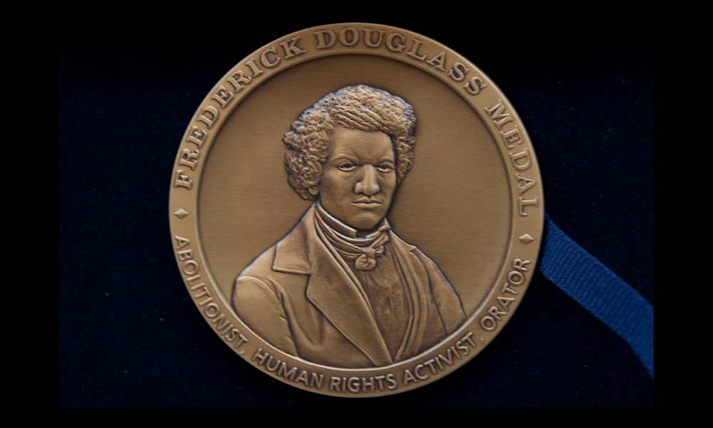 engraved medal featuring the face of Frederick Douglass