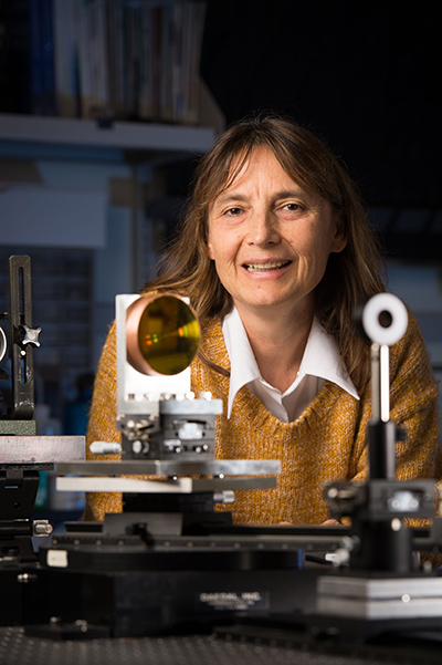 Jannick Rolland in lab, surrounded by lenses