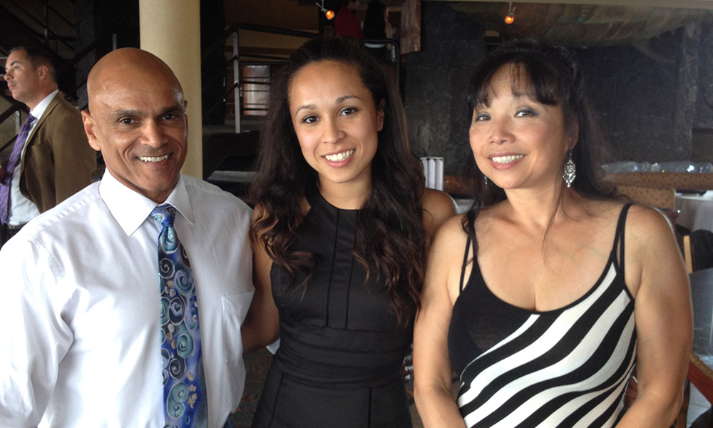 photo of a student with her parents included with a graduation thank you message