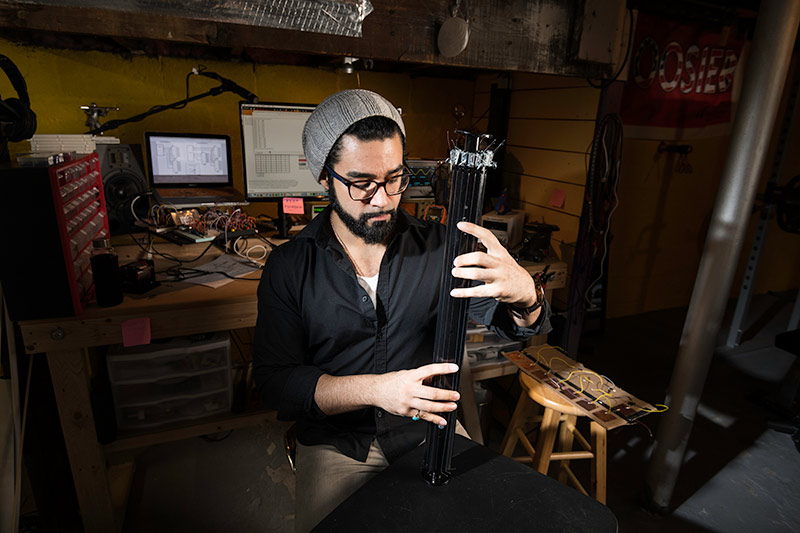 man playing a new style of guitar neck