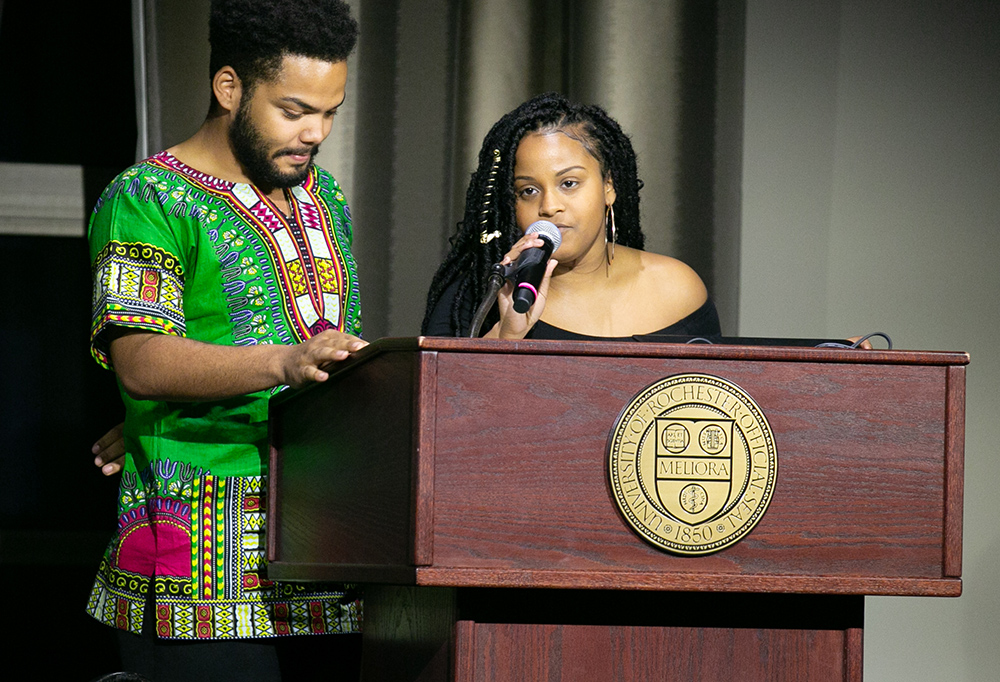 two students behind the podium