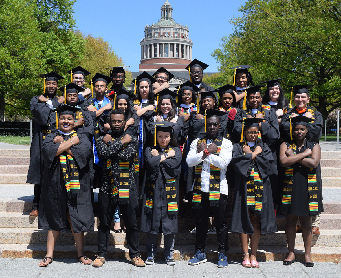 Feature image large group portrait of students doing the 'Wakanda Forever' salue from the movie Black Panther outside Rush Rhees Library