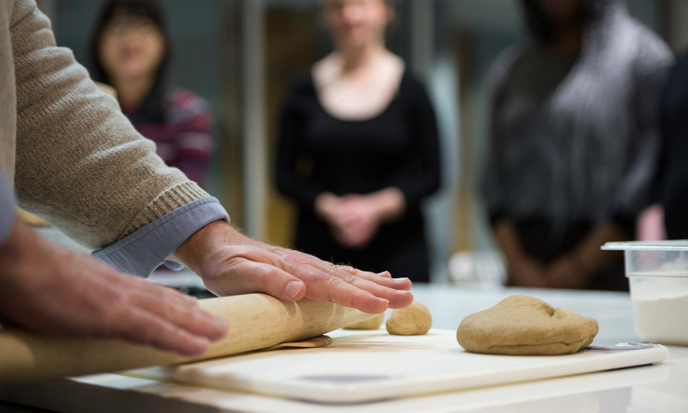 hands rolling out dough