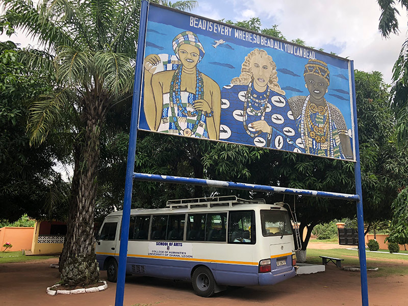 a bus is parked under a sign that reads BEAD IS EVERYWHERE, SO BEAD ALL YOU CAN BEAD