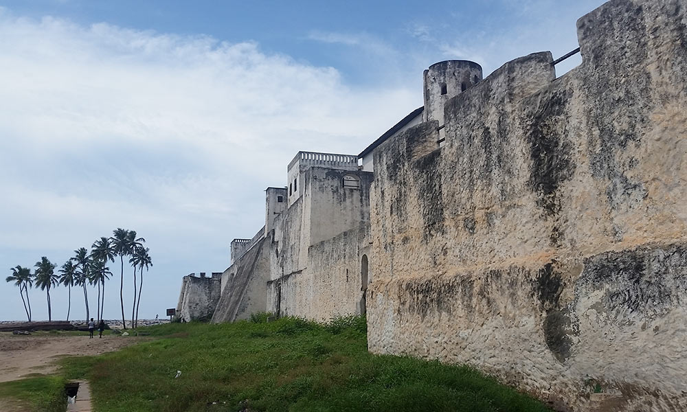 Feature image photo of a beachside fort in Ghana