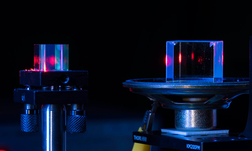 Feature image close-up of two clear cubes with beams of light shoot through them