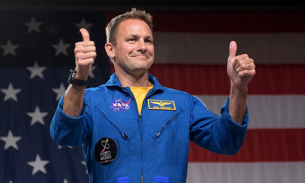 John Cassada, in astronaut uniform, giving a thumbs up