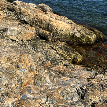 close up image of rocks with sparkling, blue crystals