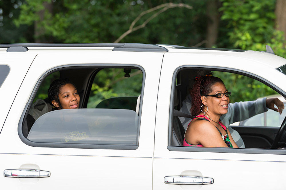 family waiting in their car