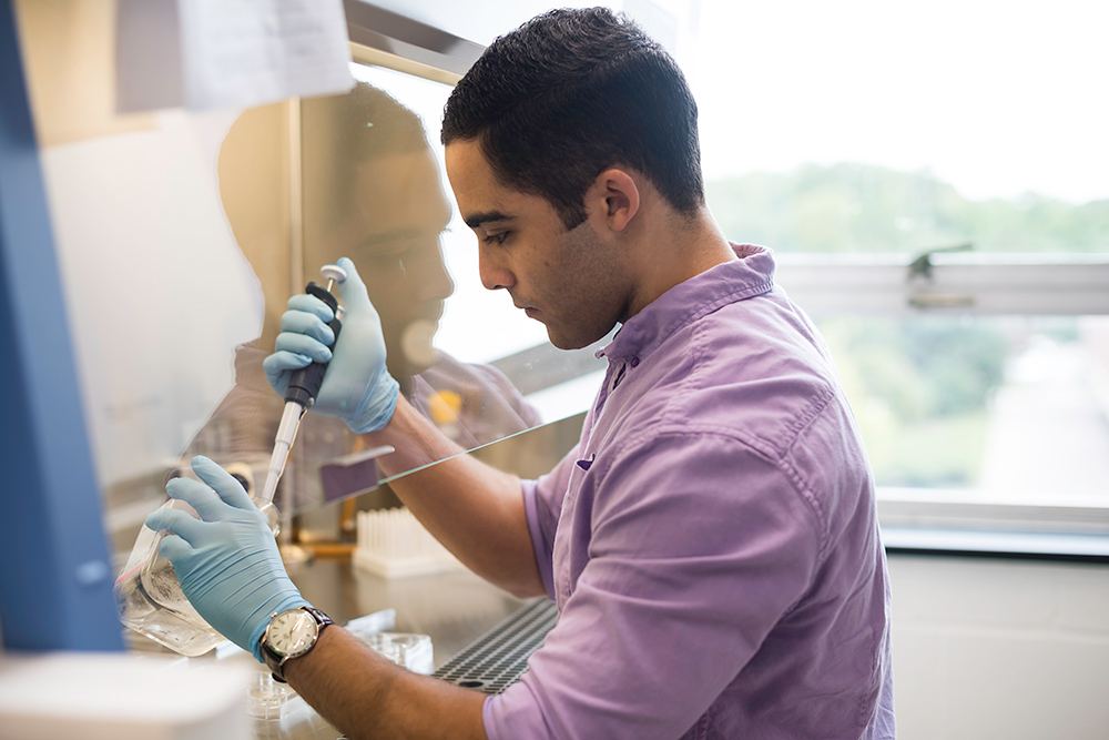 portait of Austin Skeeters working in a lab