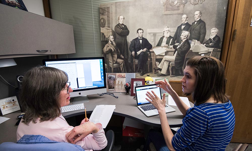 Margaret Becket and Lauren Davis working on computers to transcribe Seward papers