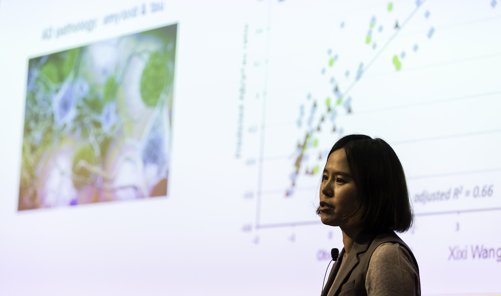 woman gives presentation in front of a screen