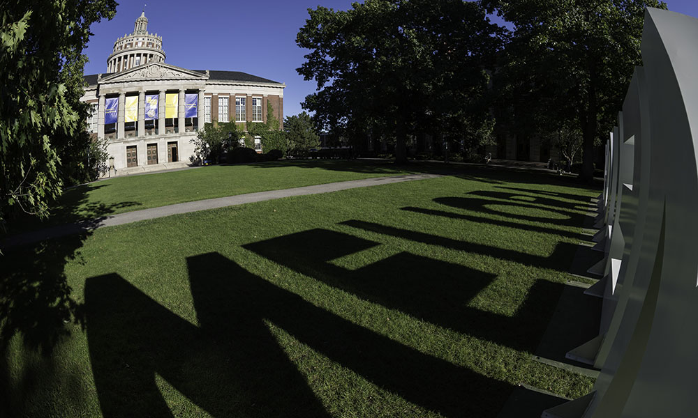 shadow of meliora letters with rush rhees library tower in the background