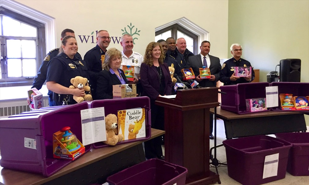 Feature image DPS officers with other local law enforcement teams stand with purple boxes and donated gifts for the Willow Domestic Violence Centeromestic Violence Center