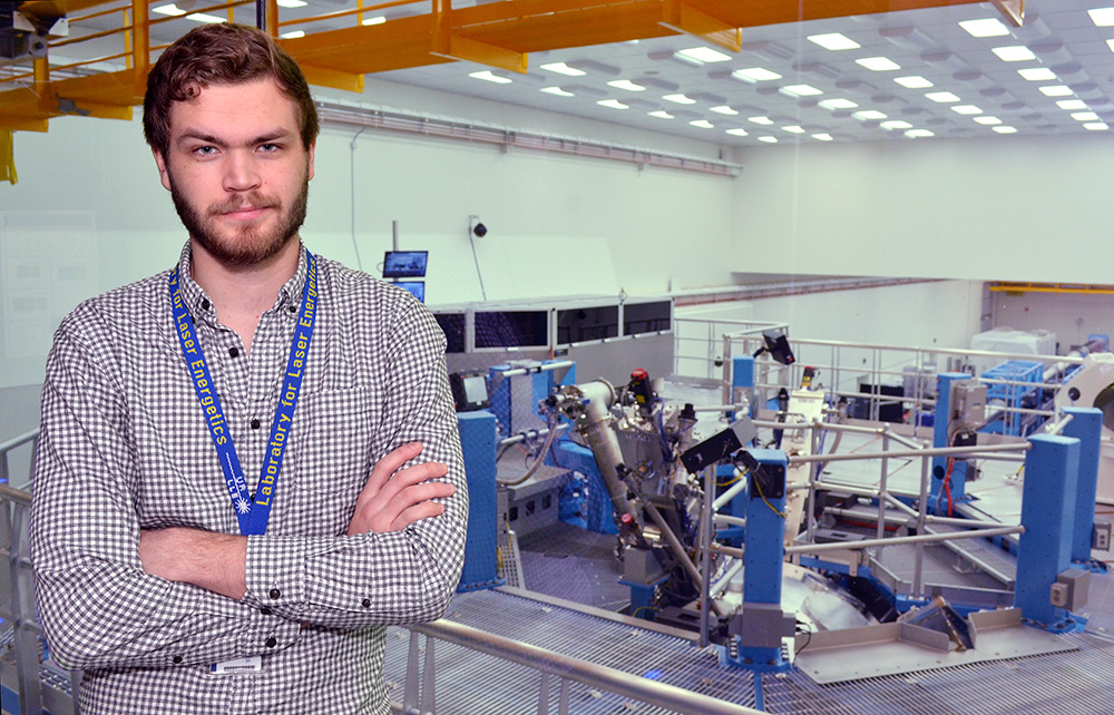 students stands in front of the OMEGA laser lab