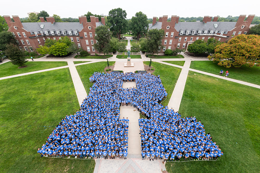 overhead shot of a large group of students arranged to form the letter R.