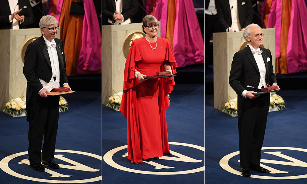 portraits of three individuals on stage holding their Nobel Prizes