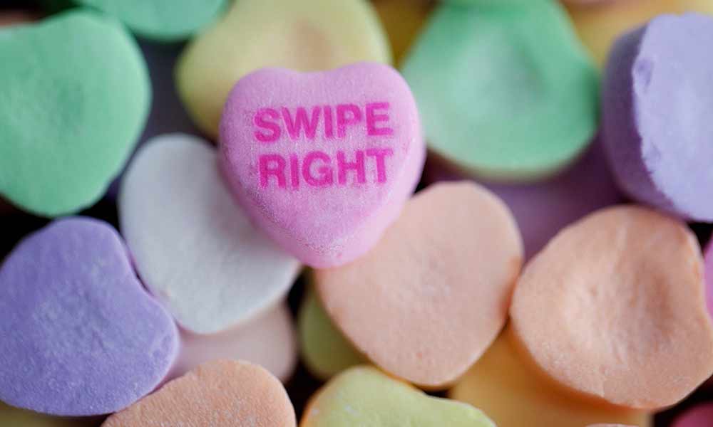 Feature image collage of candy conversation hearts, one of them says SWIPE RIGHT