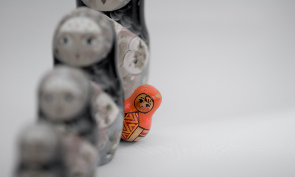 Feature image a line of Russian nesting dolls, all grey, with one, small, brightly colored one poking its head out