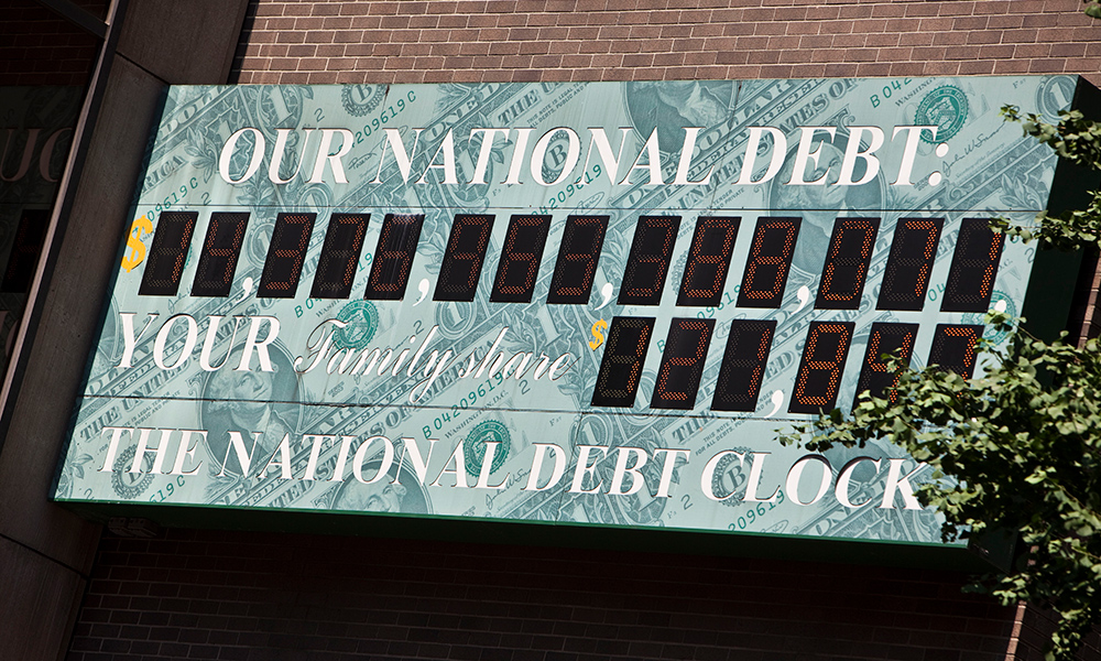 Feature image the National Debt Clock in New York City, the numbers a blacked out so you cannot read them.