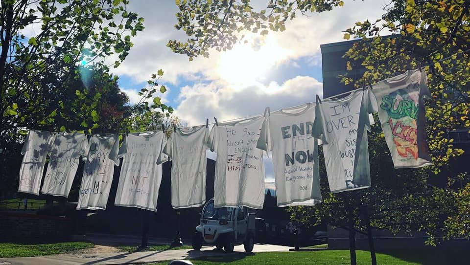 a clothesline if covered with t-shirt carrying messages of support for survivors of sexual assault.