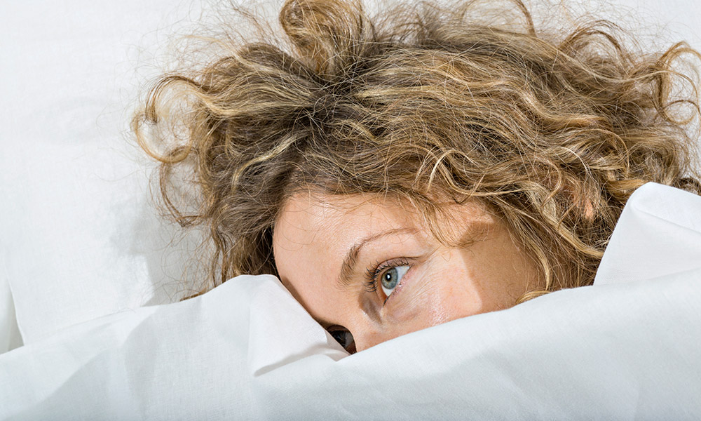 Woman with head on pillow.