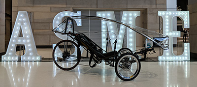 vehicle in front of large letters for ASME