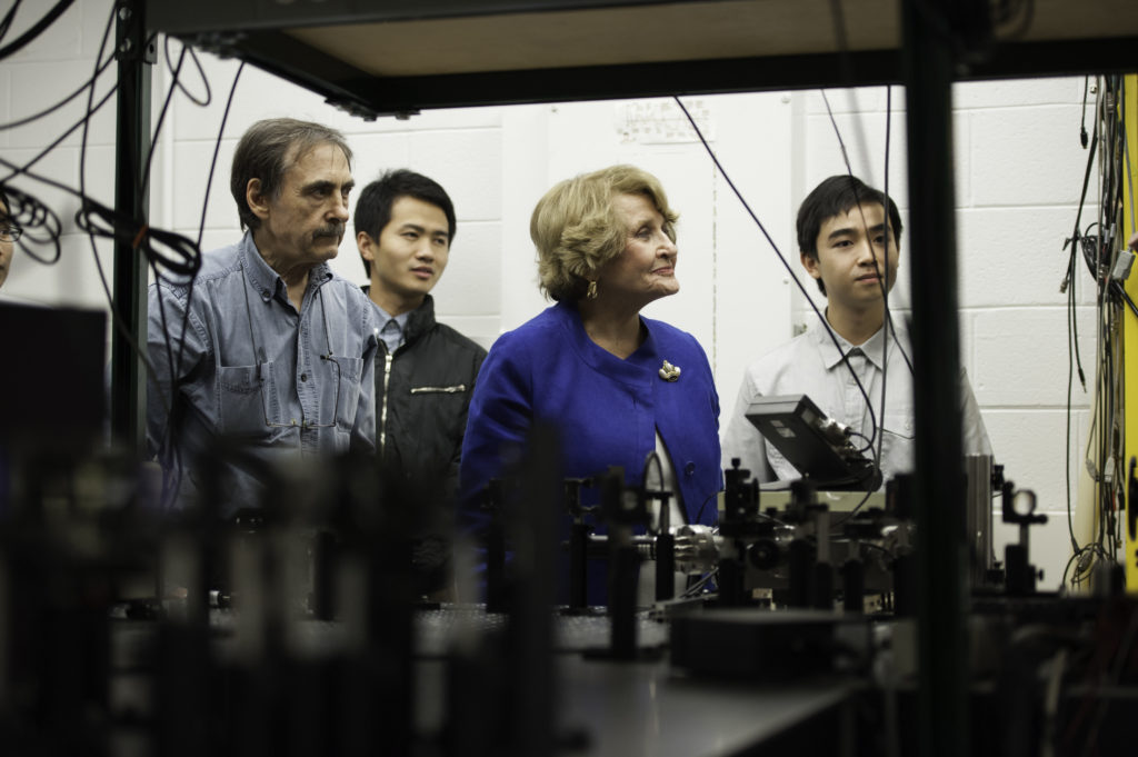 Louise Slaughter in a lab with three other scientists.