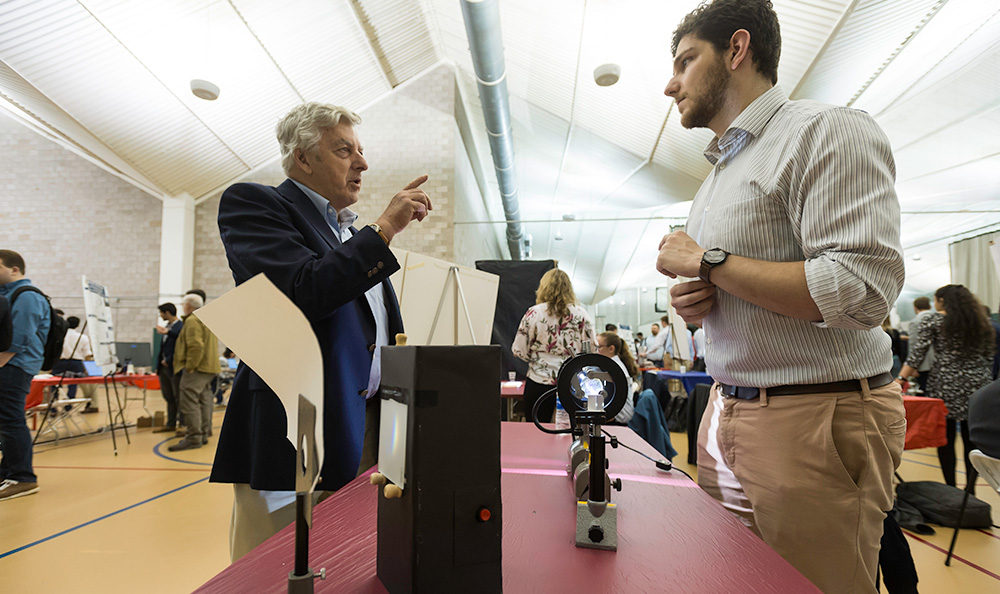 student at a table filled with optics and lenses