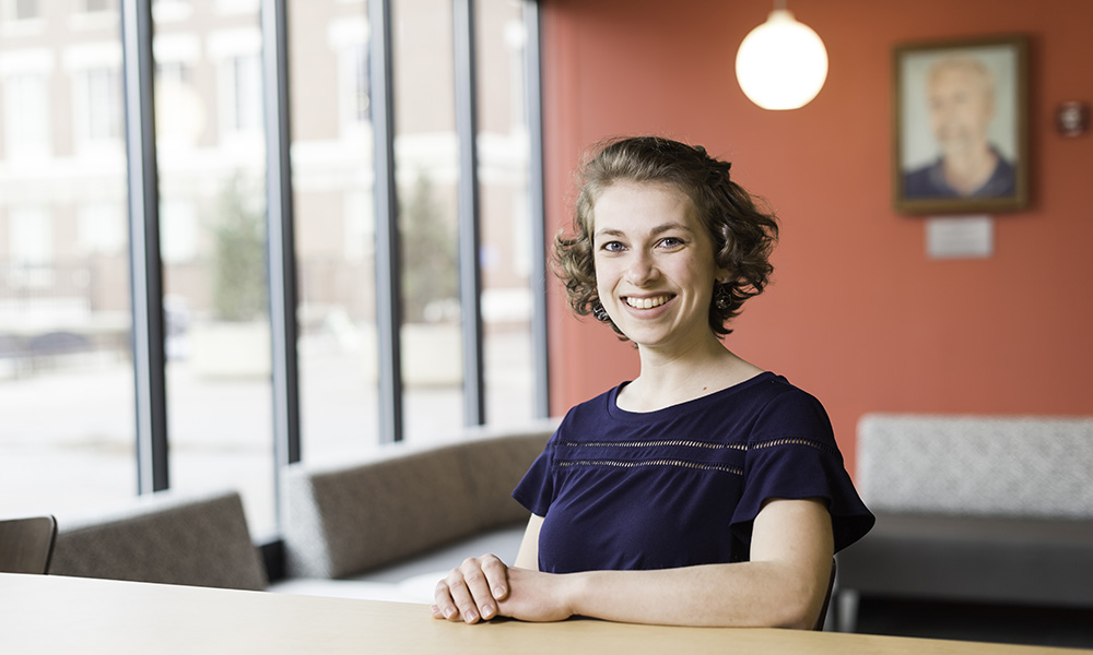Hannah Dick seated in Meliora Hall