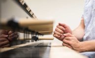 close up of hands playing the wooden hammers of the carillon