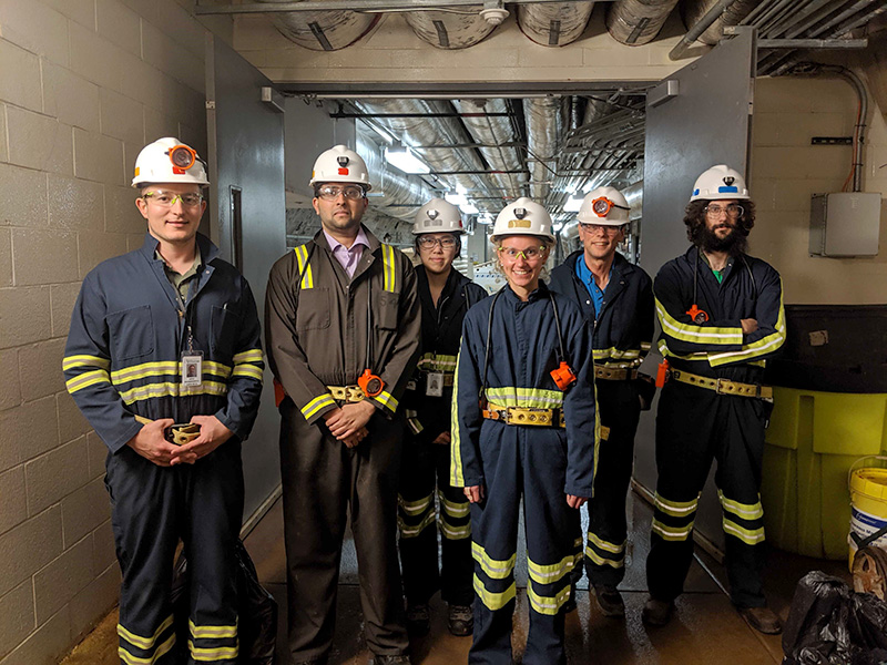 group photo of six scientists in hard hats.